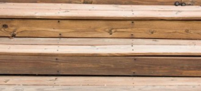 Wood steps leading from a wooden deck.