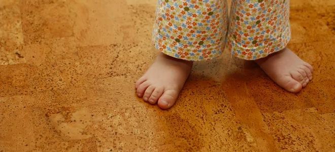 child standing on cork flooring