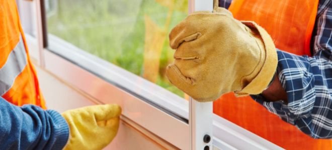 gloved hands installing new window