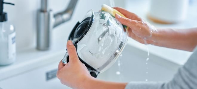 hands cleaning coffee pot
