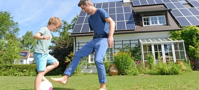 father and son in front of active solar powered house