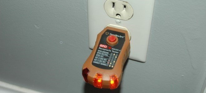 outlet tester plugged into wall socket
