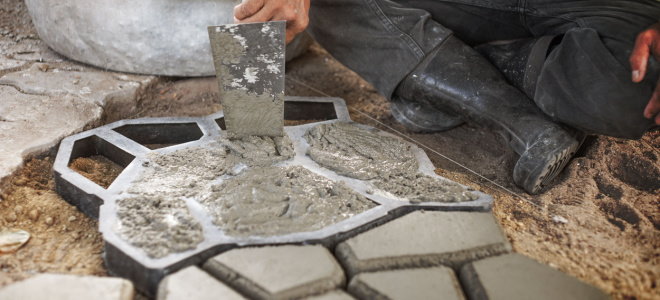 person making concrete paver with mold