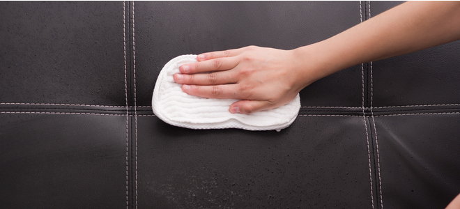 hand cleaning couch with microfiber