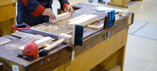 person working at carpentry workbench