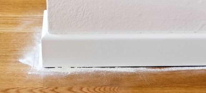 lines of powder along baseboard and floor