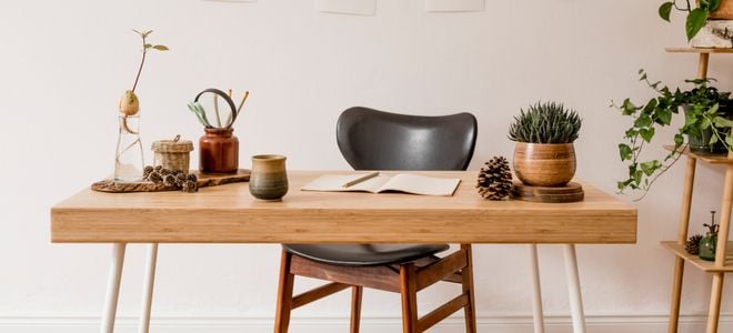 wood table and chair with natural design elements like plants and pinecones