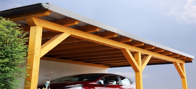 A car under a carport to protect the paint from the sun. 