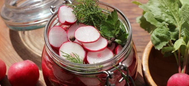 pickling radishes in a glass jar