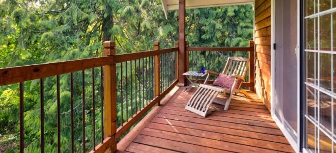 cedar deck with chair near evergreen trees