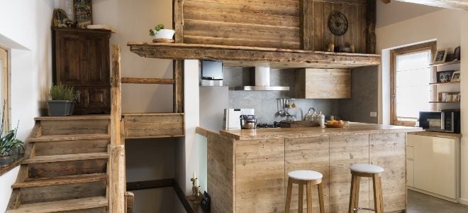 rustic bar room with wooden surfaces and stools