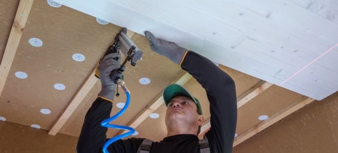 man installing basement ceiling