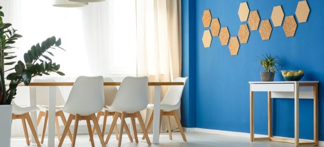 dining room with blue accent wall featuring wooden shapes