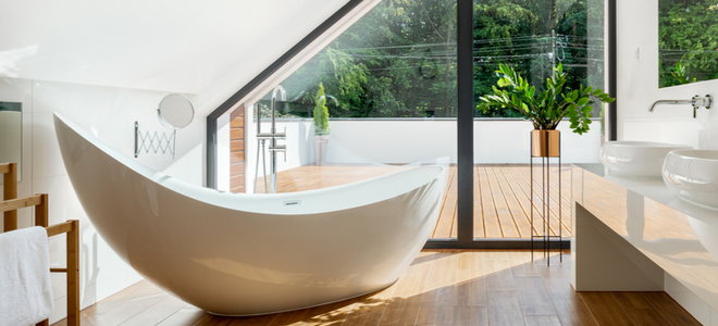 small bathroom with glass wall and free standing bath