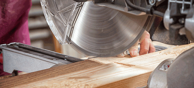 cutting a board with a miter saw