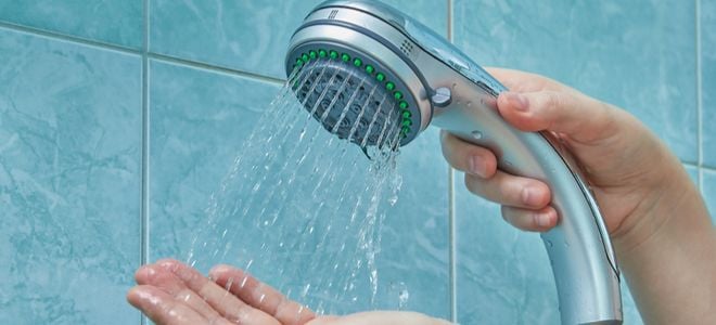 hand using hose and nozzle shower head