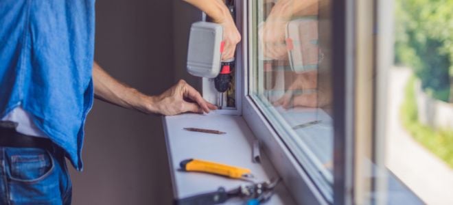 person with tools working on sliding window