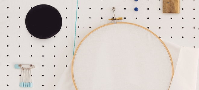 sewing supplies hanging on a pegboard