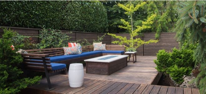patio deck area with wood surfaces, plants, and natural furniture
