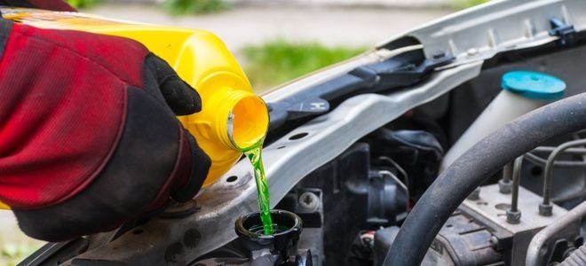 Pouring radiator coolant into a radiator 