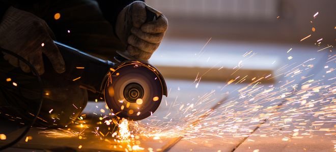 angle grinder cutting metal with sparks flying