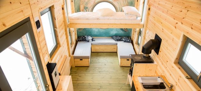 tiny home with wood paneling and wood stove