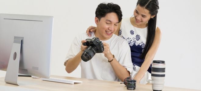smiling boy and girl looking at camera near computer