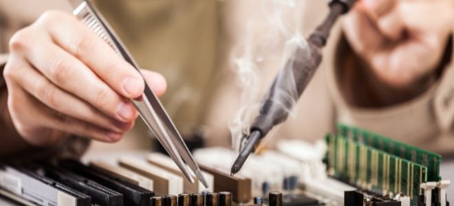 hands using smoking soldering tools