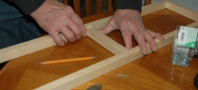 hands working with painting frame