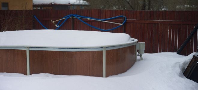 above ground pool covered in snow