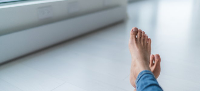 bare feet in room with baseboard heater