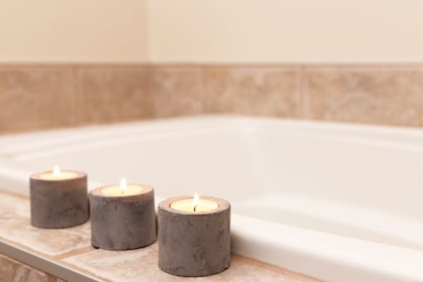 bathtub with lit candles on the edge