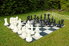 A life-sized backyard chess board in a backyard. 
