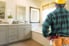 man with tools looking at remodeled bathroom