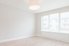 a white empty room with wood floors