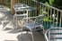 A small chair and table set of aluminum furniture.