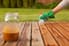 person staining deck boards