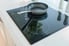 induction stove top with pan in stylish kitchen
