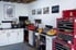 a clean garage with cabinets and tool storage