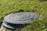 Septic tank lid surrounded by lawn