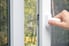 Person shutting a white storm door