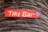 Tiki bar sign on  tree