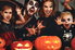 family in halloween costumes with pumpkins