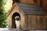 A pug in a dog house.