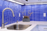 a kitchen with blue tile backsplash