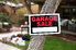 A garage sale sign on a tree.
