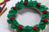 felt holiday wreath on graph paper with supplies