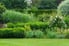 green lawn with bushy garden