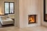 travertine home wall and floor design with fireplace and mirror