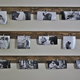 A grouping of photos hanging from wood pieces.